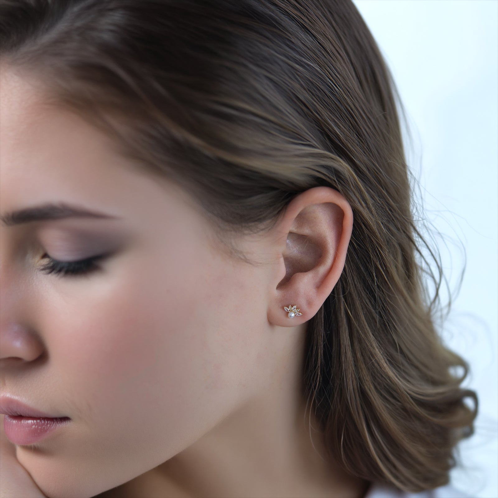 9ct gold pearl and crystal stud earring in a models ear 