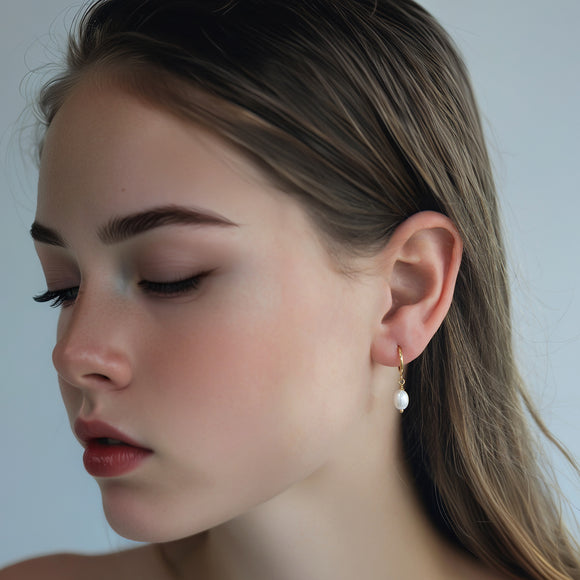 freshwater pearl hoop earrings in gold filled with an oval pearl 