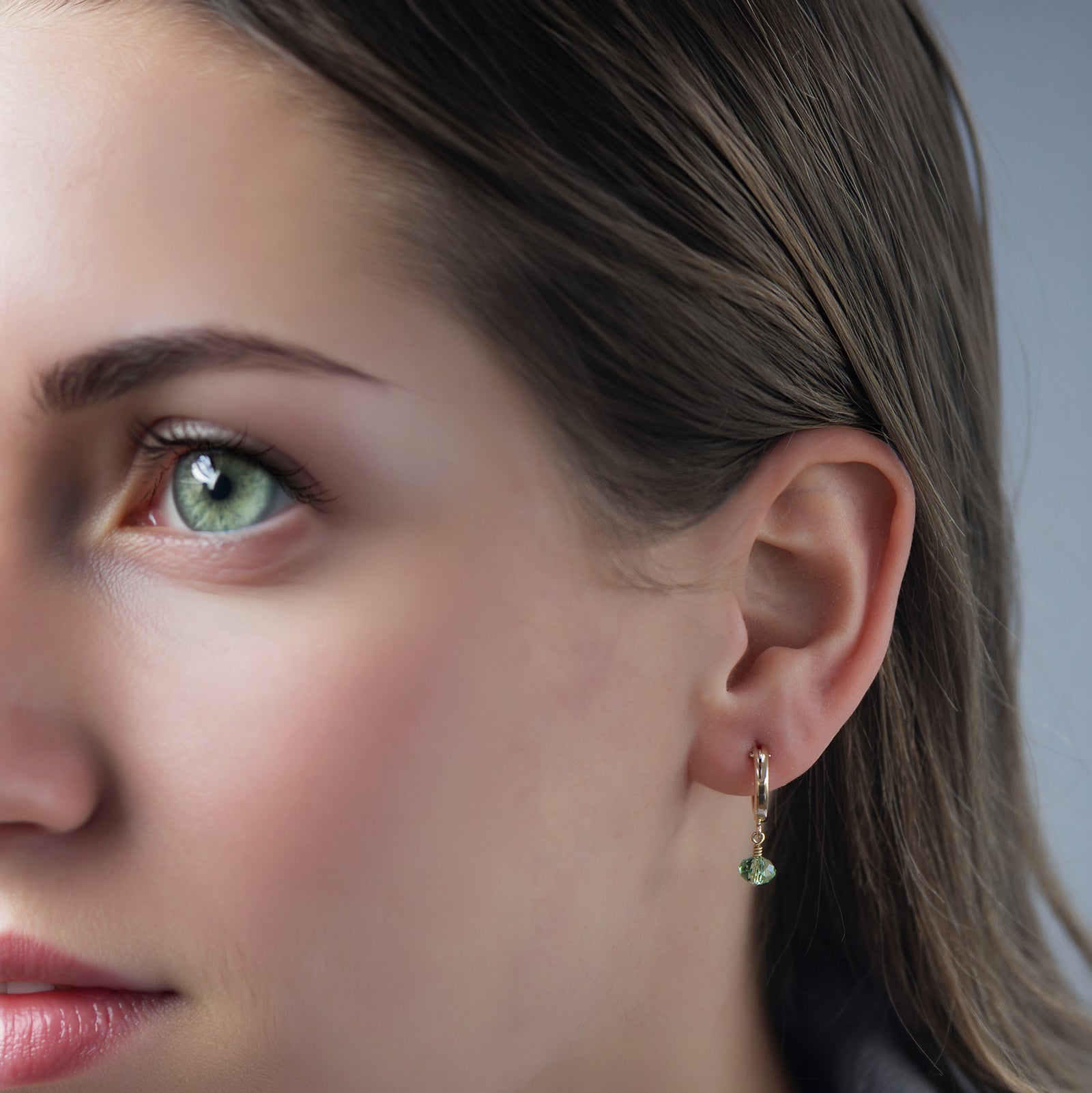 august birthstone earrings on a model 