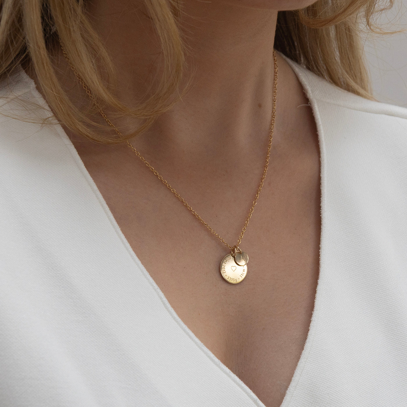 New mom wearing gold Birthcoin engraved birth necklace – personalised keepsake jewellery celebrating baby’s arrival.