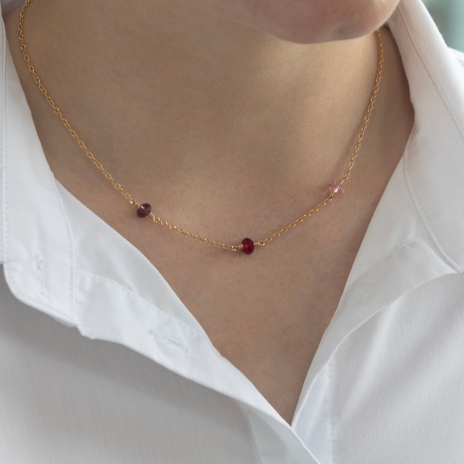 family birthstone necklace with three stones on a model 