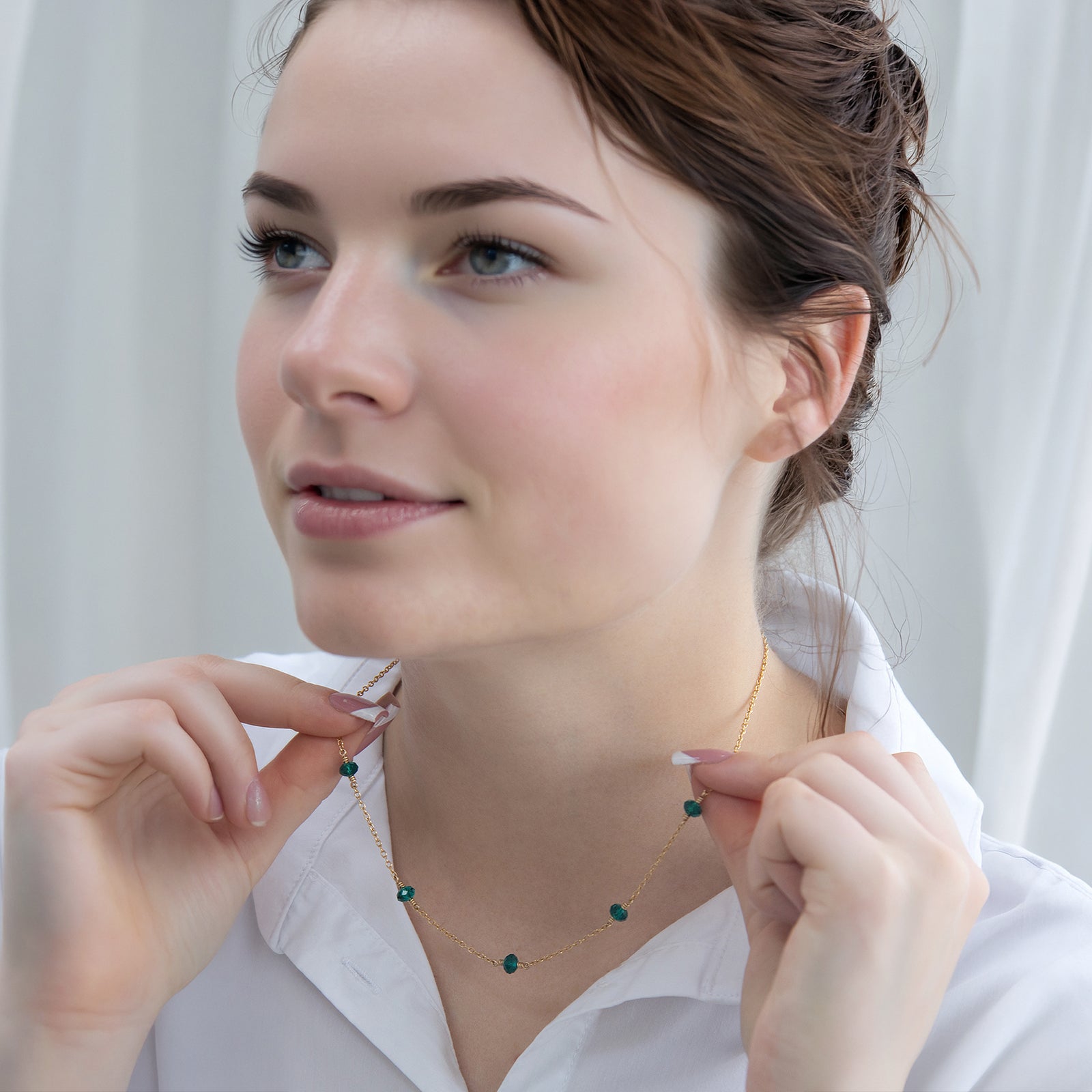 family birthstone necklace with five stones on a model with a white backdrop 