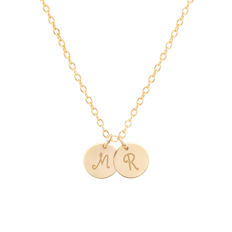 dainty gold initial necklace with multiple discs in script font product shot 