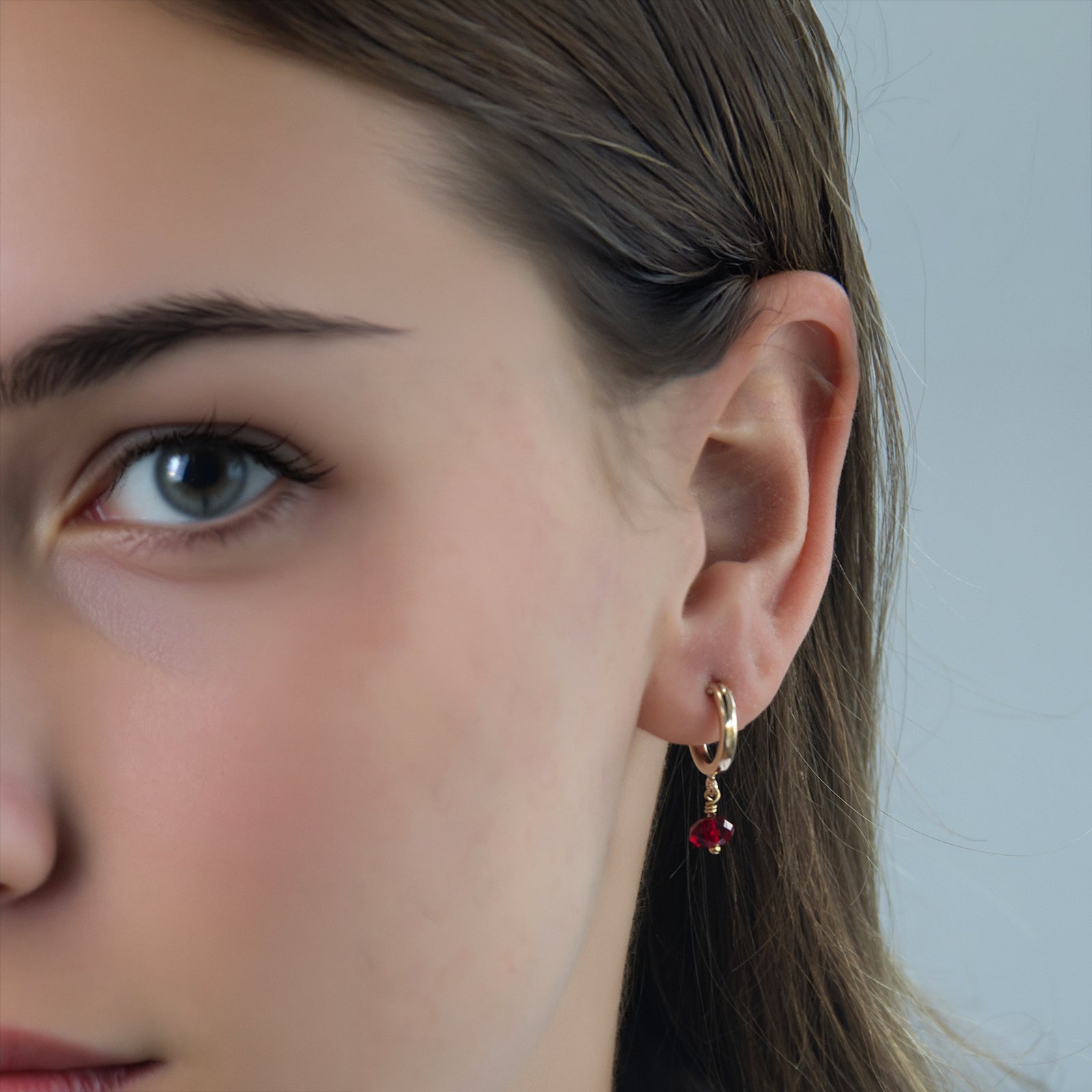 july hoop earring on a models ear 