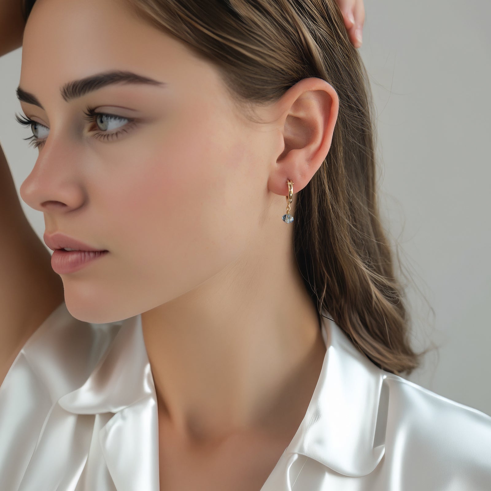 march birthstone hoop earrings on a model 