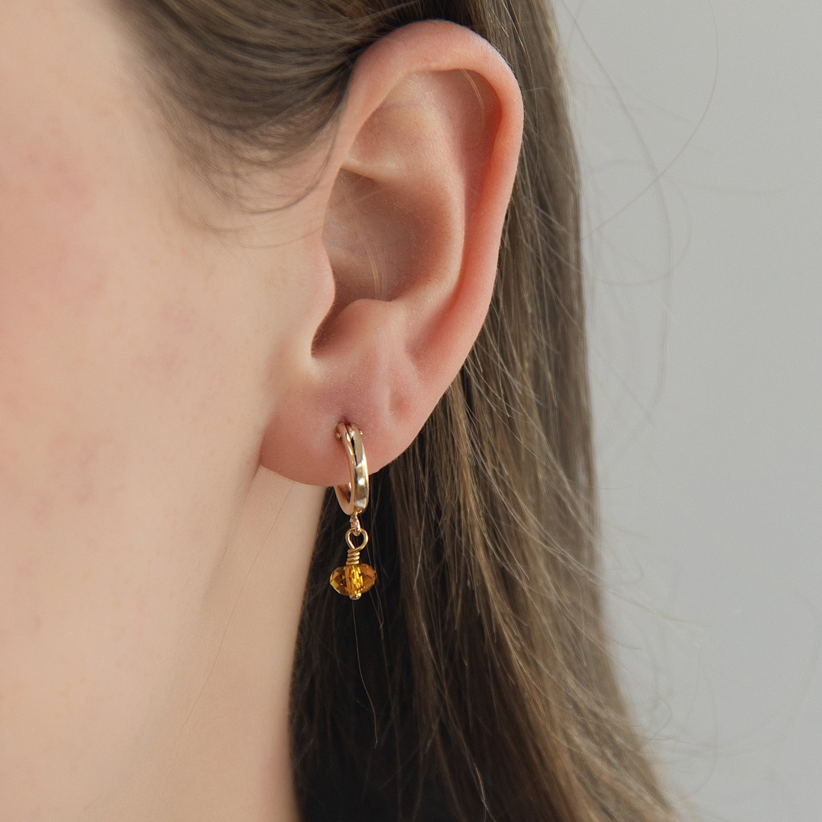 november birthstone earrings on a model close up 